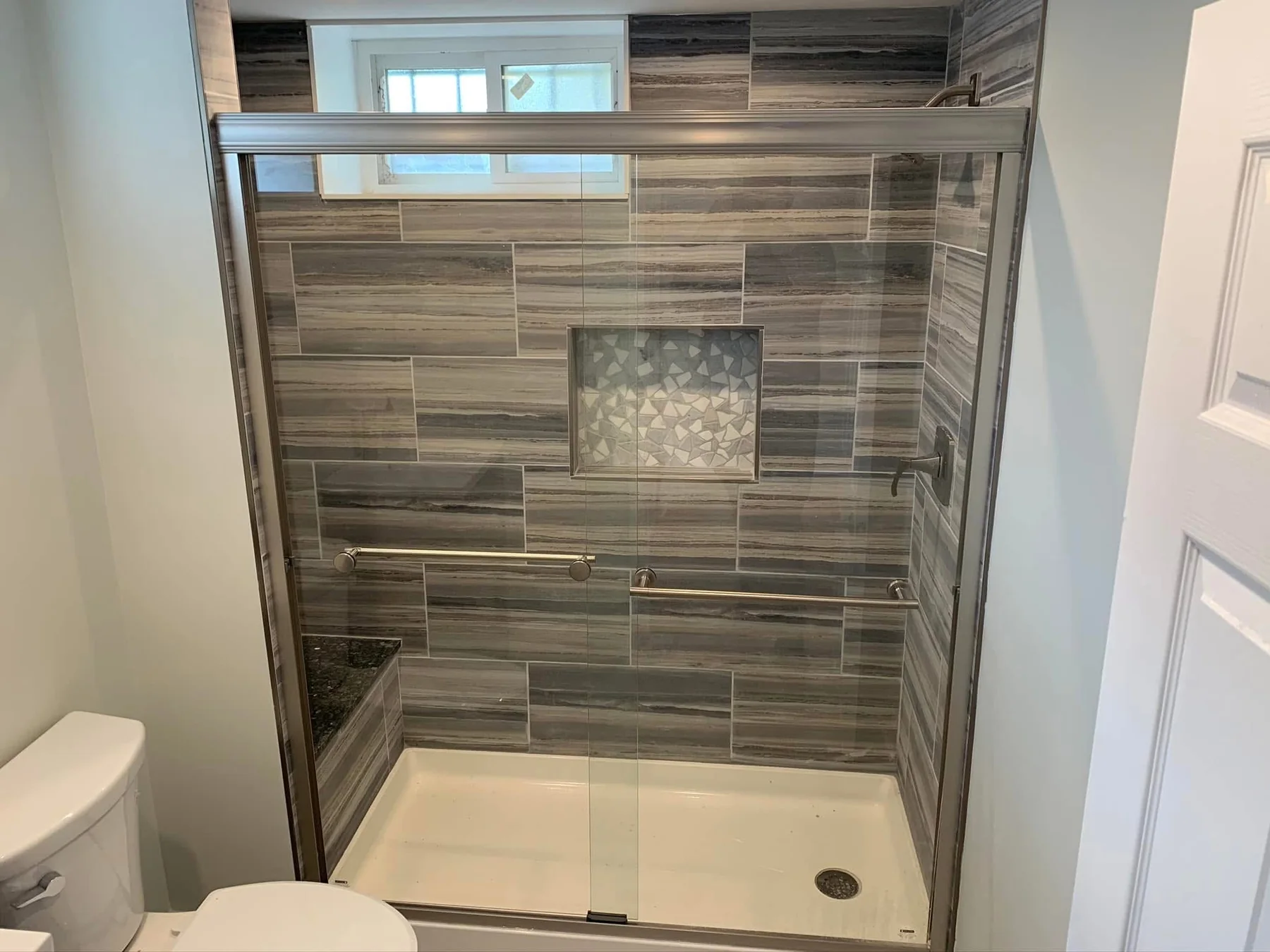 Updated shower in layered stone-pattern tile