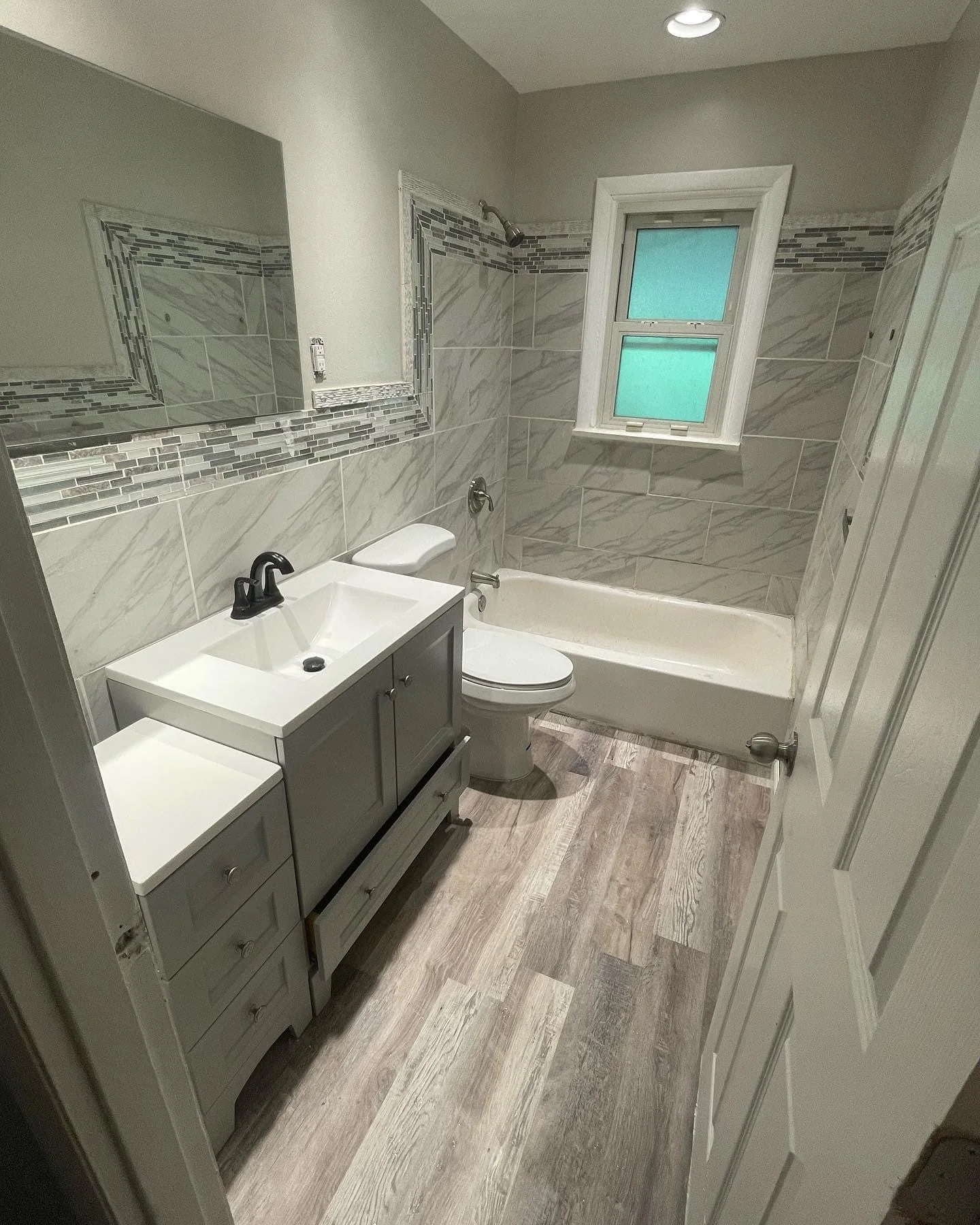 Bright finished marble-look tiled shower