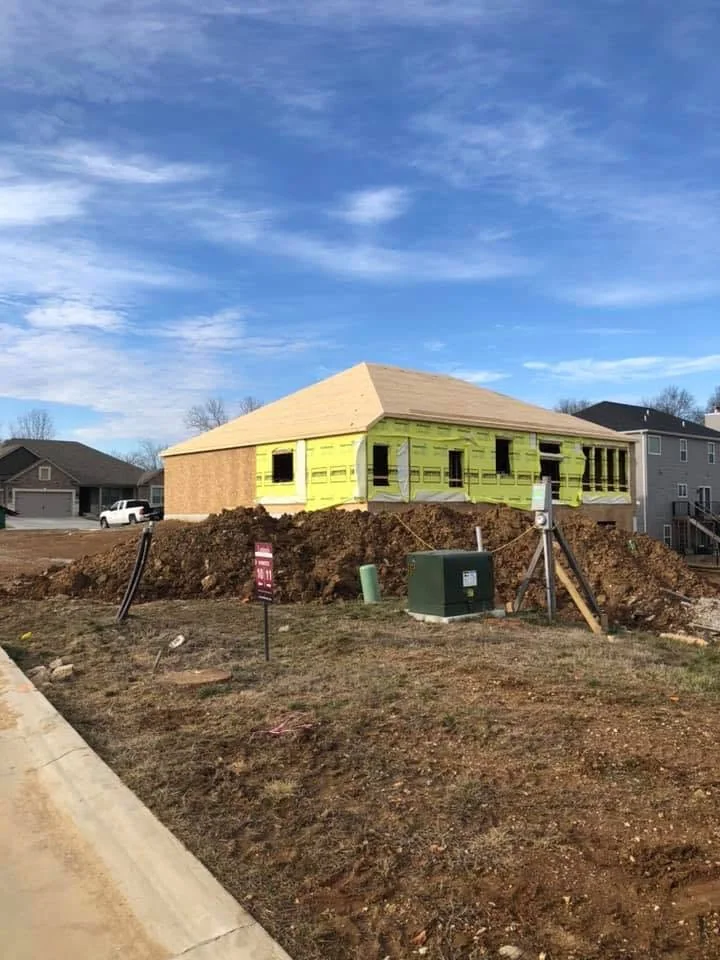 Newly framed house with sheathed exterior walls and roof under construction